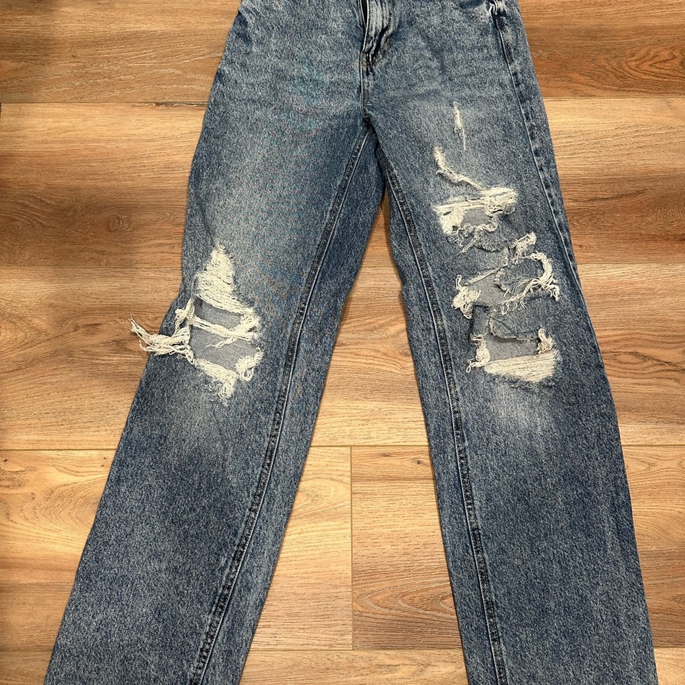 Medium wash ripped jeans.